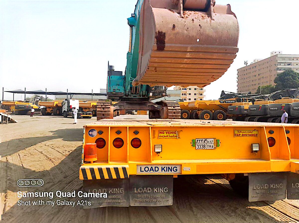 Heavy machinery transport — excavator on flatbed