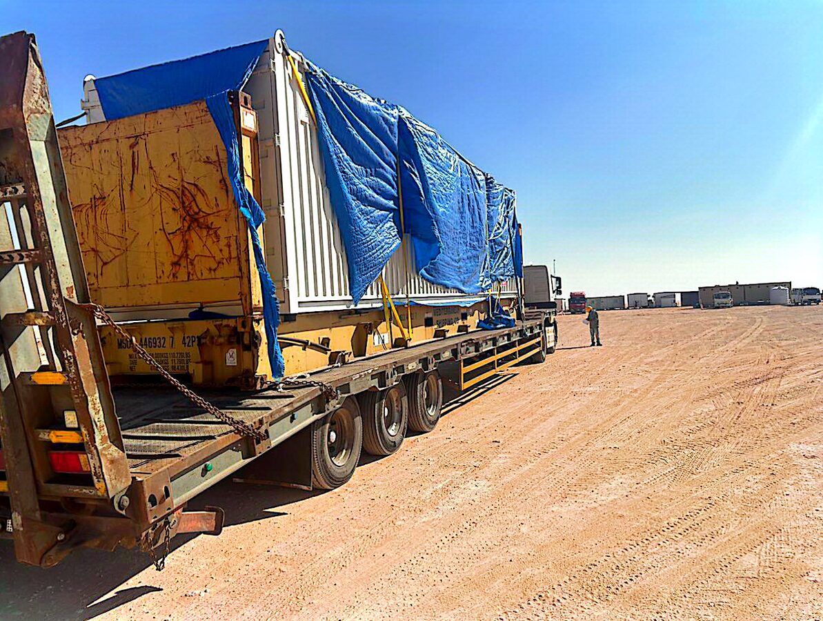 Wide-load cargo secured on multi-axle trailer